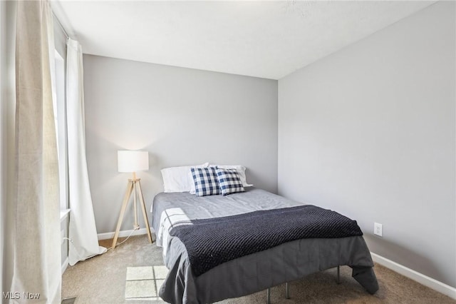 carpeted bedroom with baseboards