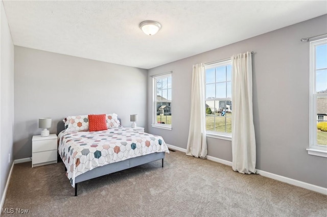 bedroom featuring carpet flooring and baseboards