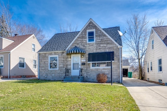 view of front of home featuring a front lawn, driveway, stone siding, and roof with shingles