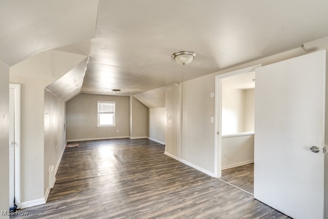 bonus room with vaulted ceiling, wood finished floors, and baseboards