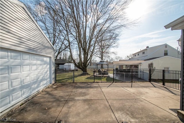 view of patio / terrace with a playground, a garage, and fence