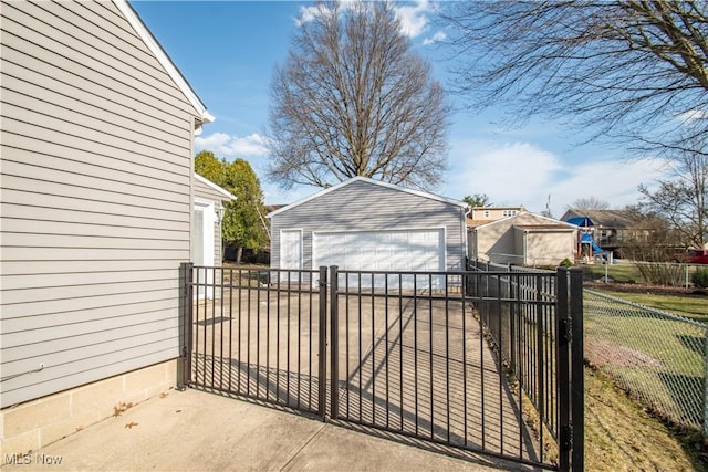 view of gate featuring an outbuilding and fence