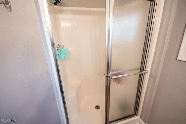 bathroom featuring a shower stall