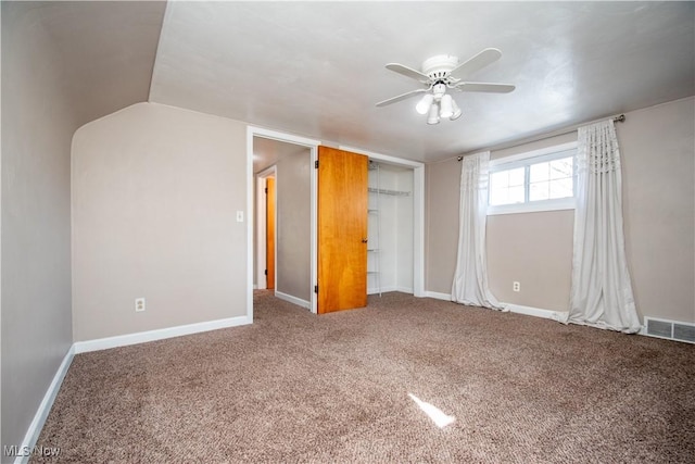 unfurnished bedroom with visible vents, ceiling fan, baseboards, carpet, and a closet