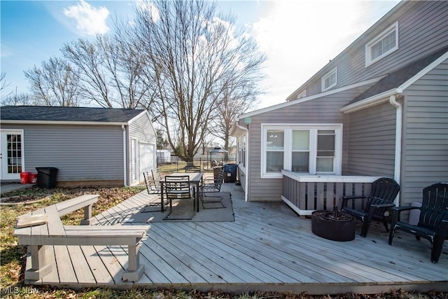 deck featuring outdoor dining space and an outdoor structure