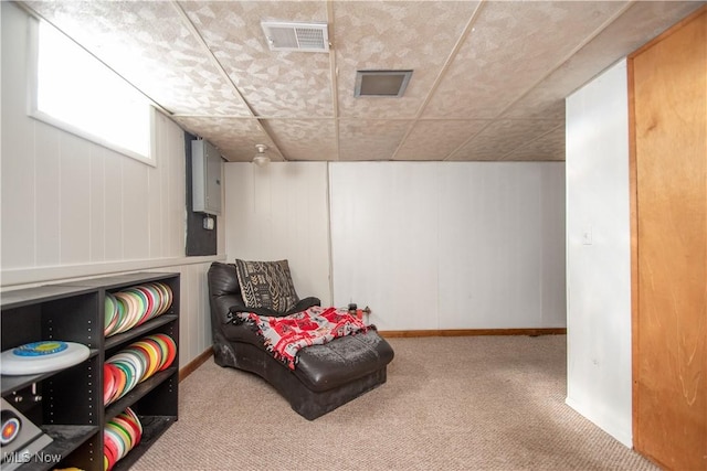 living area with visible vents and carpet