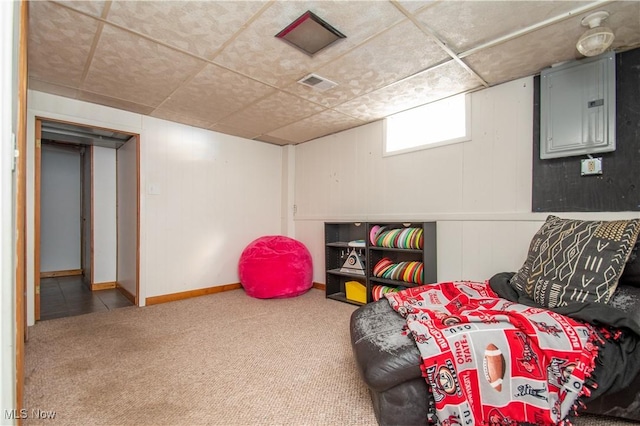 living area featuring electric panel, visible vents, carpet floors, and baseboards