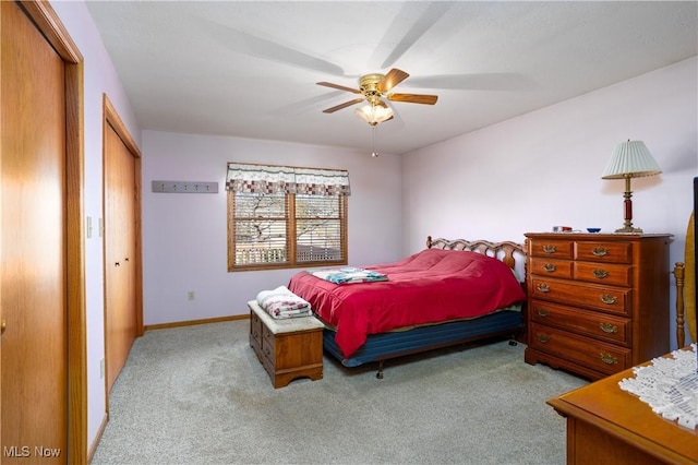 bedroom featuring a closet, a ceiling fan, baseboards, and carpet floors