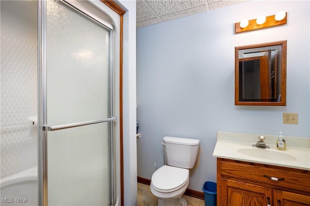 full bathroom featuring vanity, toilet, baseboards, and a stall shower