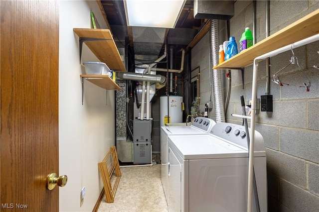 clothes washing area featuring heating unit, gas water heater, concrete block wall, and washer and clothes dryer