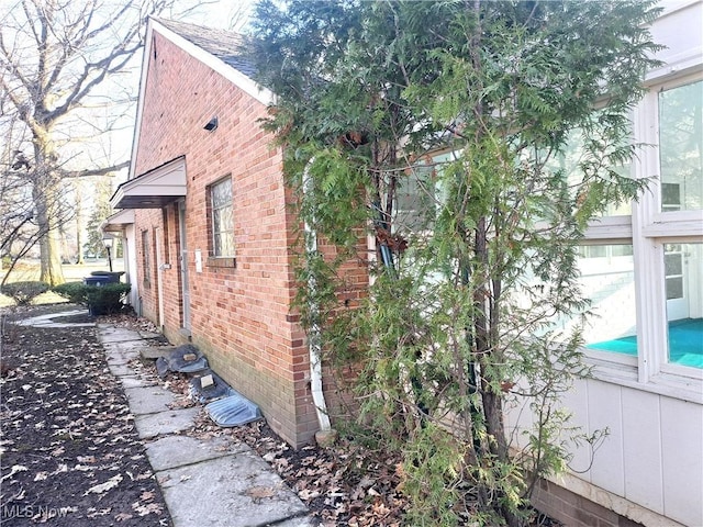 view of side of property with brick siding