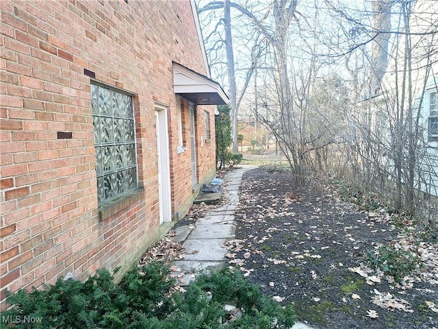 view of property exterior featuring brick siding