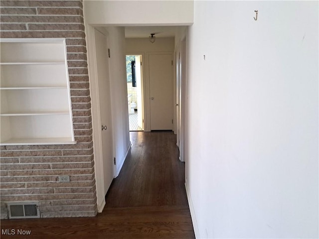 hall with visible vents and wood finished floors