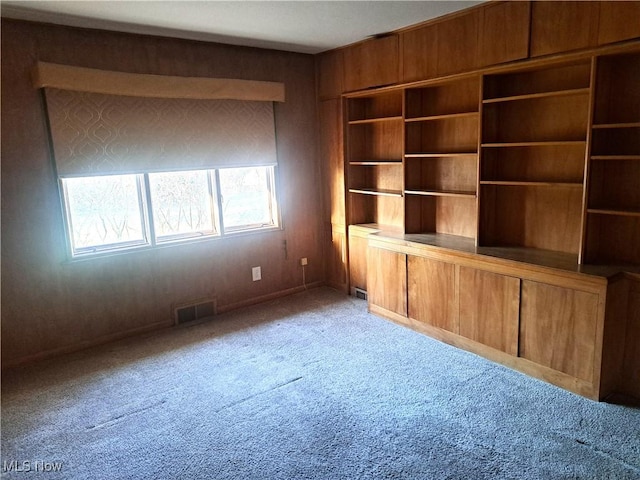 unfurnished living room featuring visible vents and light carpet