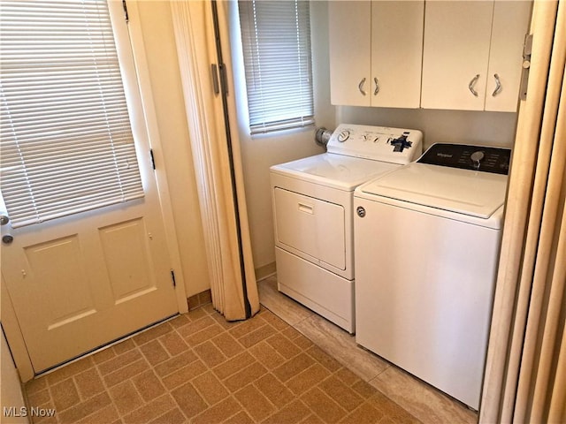 laundry area featuring washer and dryer and cabinet space