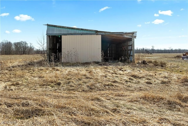 view of pole building with a rural view