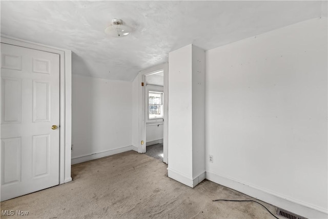 bonus room with carpet flooring, visible vents, and baseboards