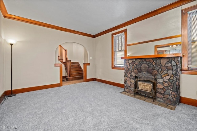 living room featuring arched walkways, stairway, carpet, and ornamental molding