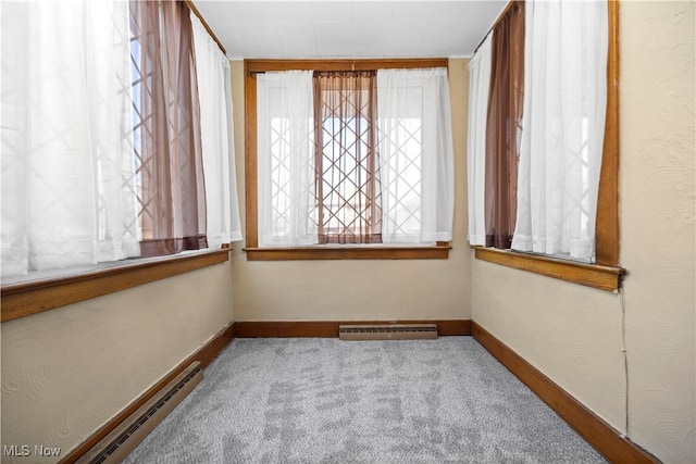 empty room with visible vents, baseboards, carpet, and a baseboard radiator