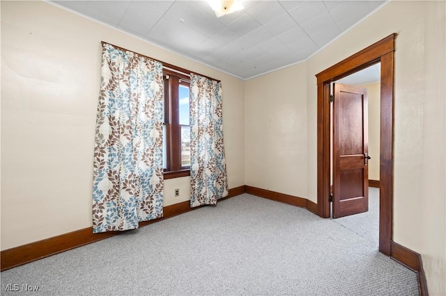 spare room featuring baseboards and carpet floors