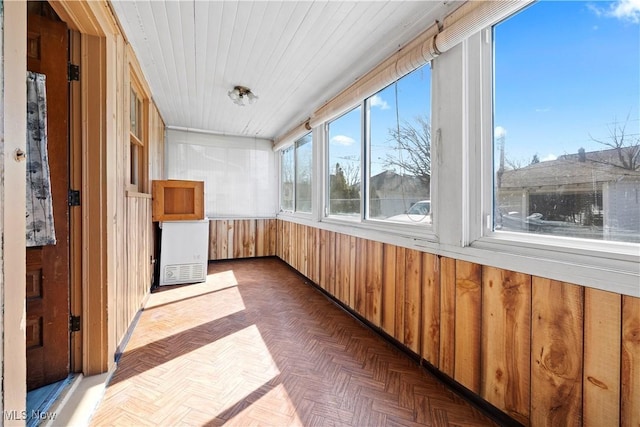 unfurnished sunroom featuring wooden ceiling