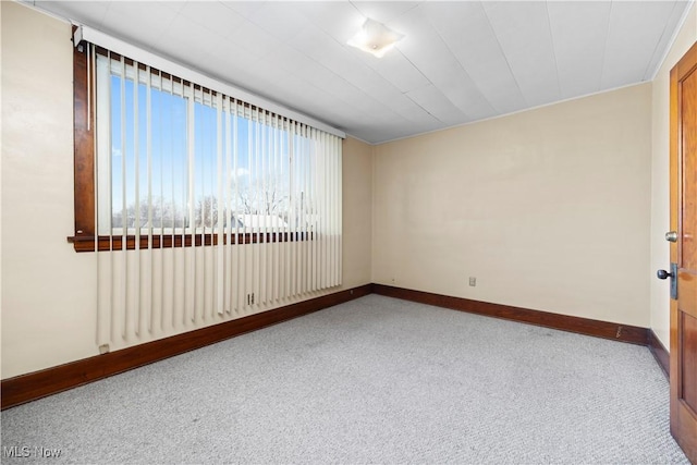 unfurnished room with baseboards