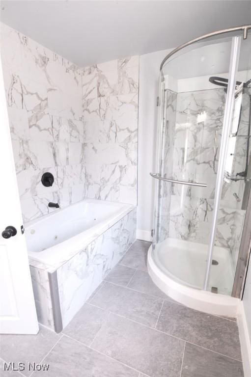 full bathroom featuring a marble finish shower and a bath