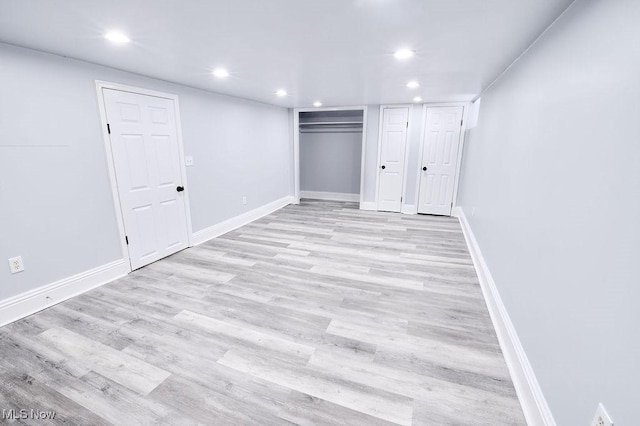 unfurnished bedroom featuring light wood finished floors, recessed lighting, and baseboards