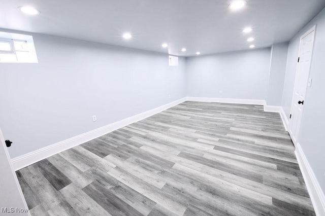 basement with recessed lighting, baseboards, and wood finished floors