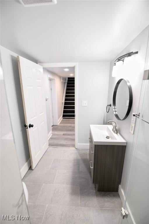 bathroom featuring visible vents, vanity, and baseboards