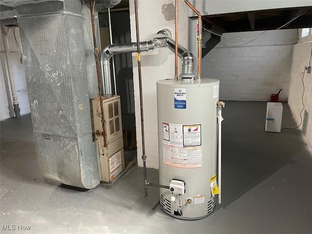 utility room with heating unit and water heater