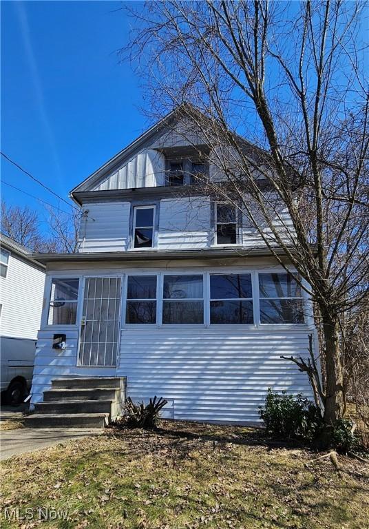 view of front of house with a sunroom and entry steps