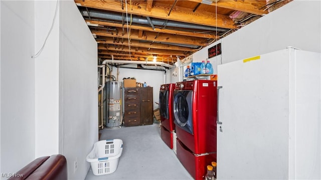 unfinished basement featuring washing machine and dryer and gas water heater