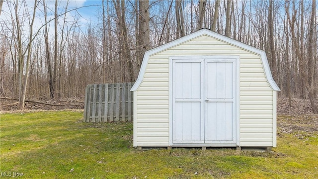 view of shed featuring fence