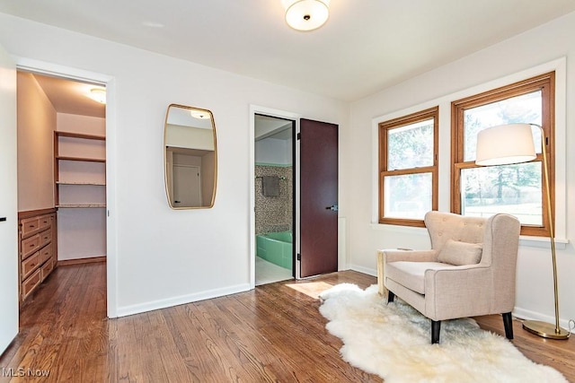 unfurnished room featuring baseboards and wood finished floors