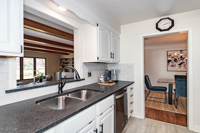 kitchen featuring light wood finished floors, dishwasher, decorative backsplash, white cabinetry, and a sink