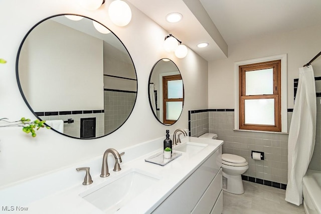 bathroom featuring a sink, toilet, tile walls, and double vanity