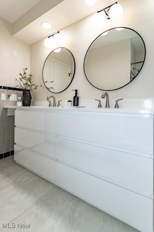 bathroom featuring double vanity and a sink