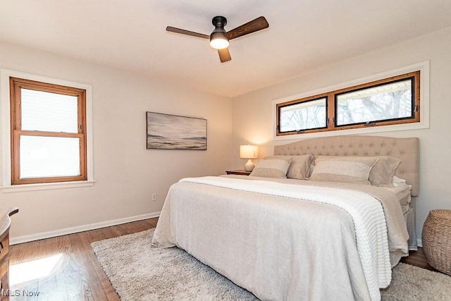 bedroom featuring a ceiling fan, wood finished floors, and baseboards