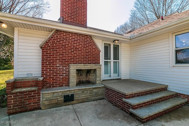 view of patio with exterior fireplace