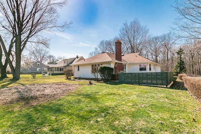 back of house with a yard and fence