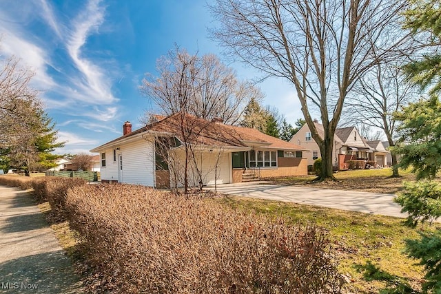 back of house featuring concrete driveway and an attached garage