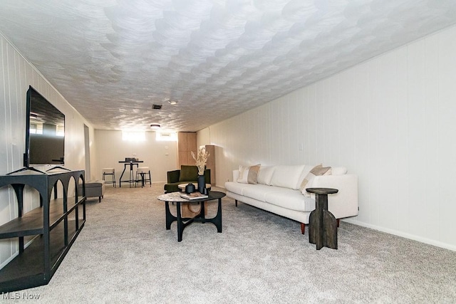 living area with carpet flooring and a textured ceiling