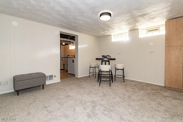 interior space featuring visible vents, carpet flooring, and a textured ceiling