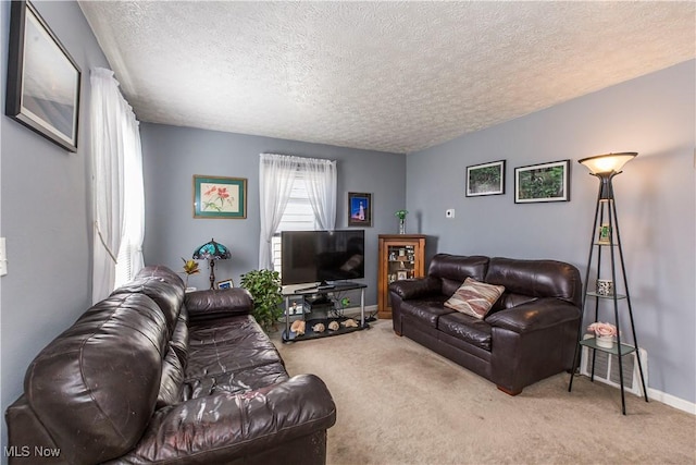 carpeted living room with baseboards and a textured ceiling