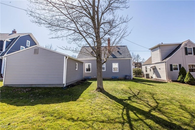 back of house with a lawn