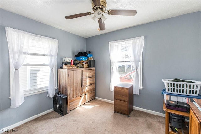 bedroom featuring baseboards, light carpet, and a ceiling fan