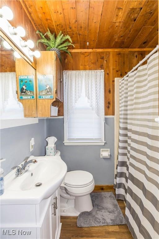 full bathroom with vanity, a shower with shower curtain, wood finished floors, wooden ceiling, and toilet