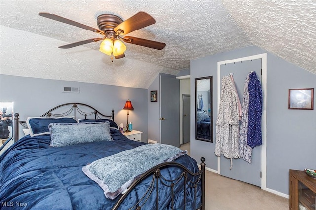 carpeted bedroom featuring visible vents, a textured ceiling, baseboards, lofted ceiling, and ceiling fan