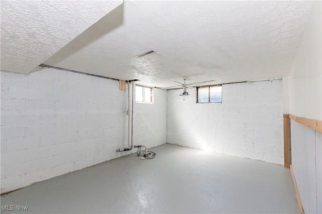 basement with visible vents and a textured ceiling